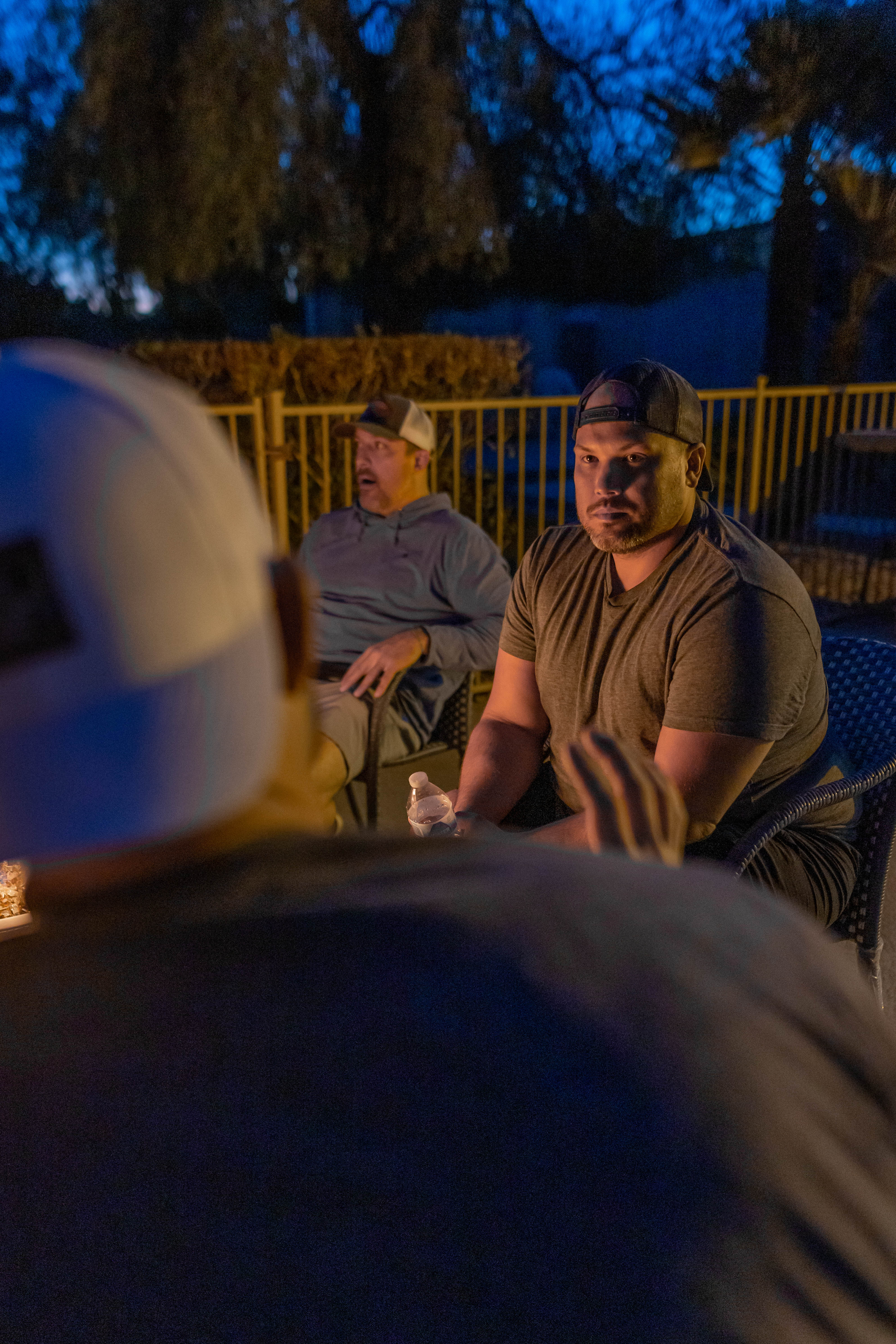 men sitting around a fire